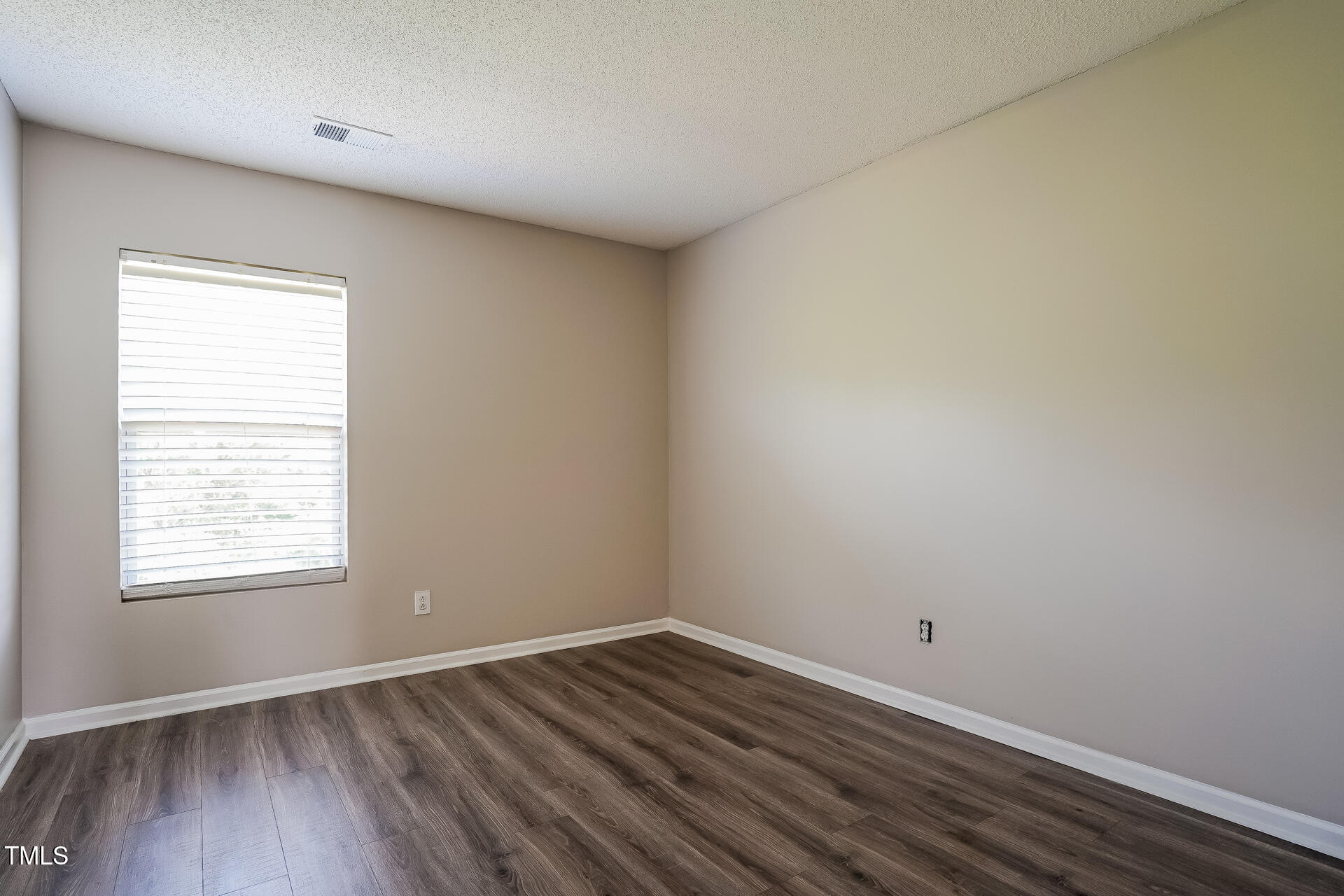 6101 Ricker Road Raleigh, NC 27610 - Photo 14 of 24 an empty room with wooden floor and windows
