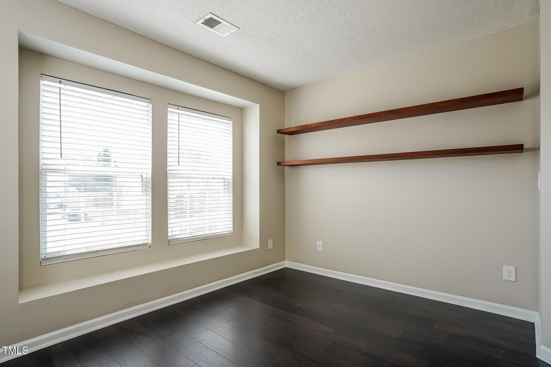 6101 Ricker Road Raleigh, NC 27610 - Photo 16 of 24 a view of an empty room with wooden floor and a window