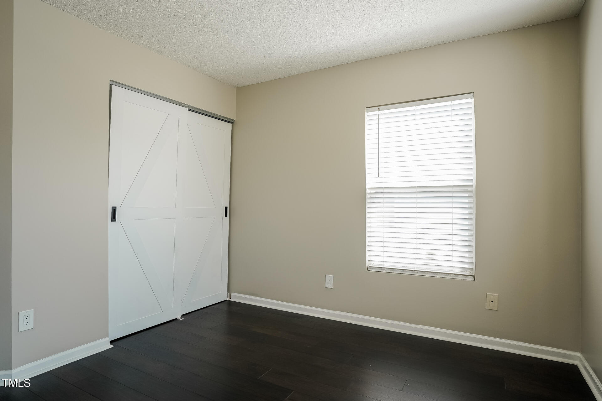6101 Ricker Road Raleigh, NC 27610 - Photo 17 of 24 a view of an empty room with wooden floor and a window