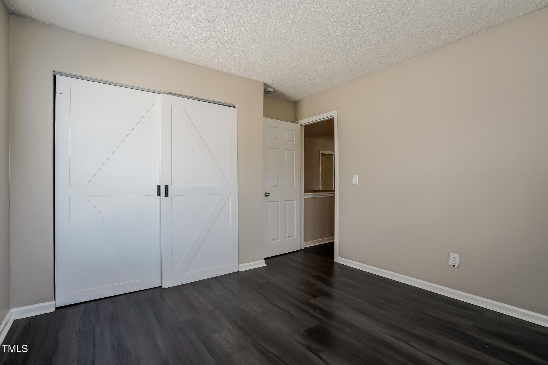 6101 Ricker Road Raleigh, NC 27610 - Photo 18 of 24 a view of an empty room with wooden floor