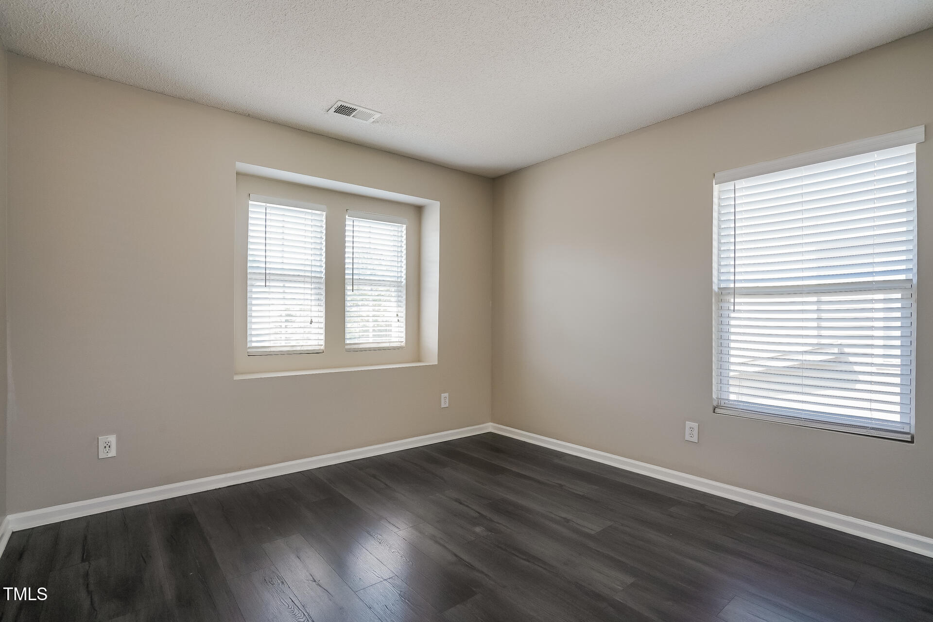 6101 Ricker Road Raleigh, NC 27610 - Photo 19 of 24 a view of an empty room with wooden floor and a window