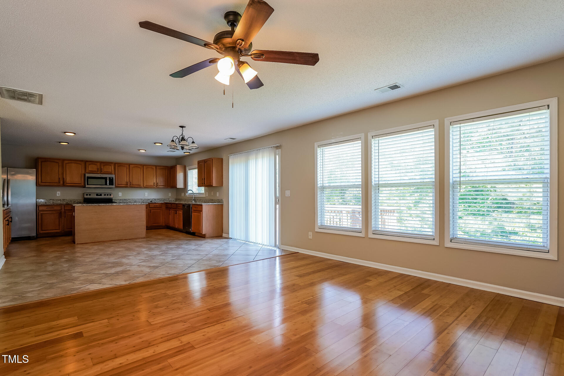 6101 Ricker Road Raleigh, NC 27610 - Photo 2 of 24 a view of an empty room with wooden floor and a window