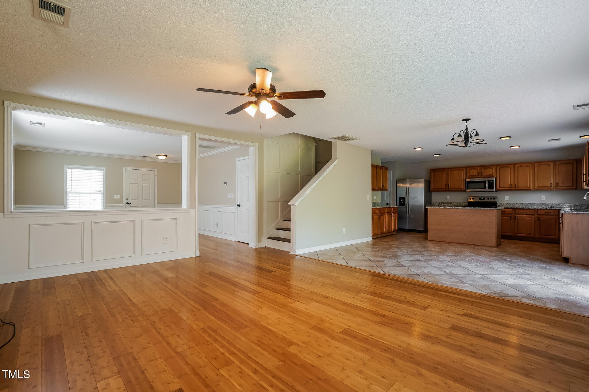 6101 Ricker Road Raleigh, NC 27610 - Photo 5 of 24 a view of a kitchen with a stove cabinets and wooden floor