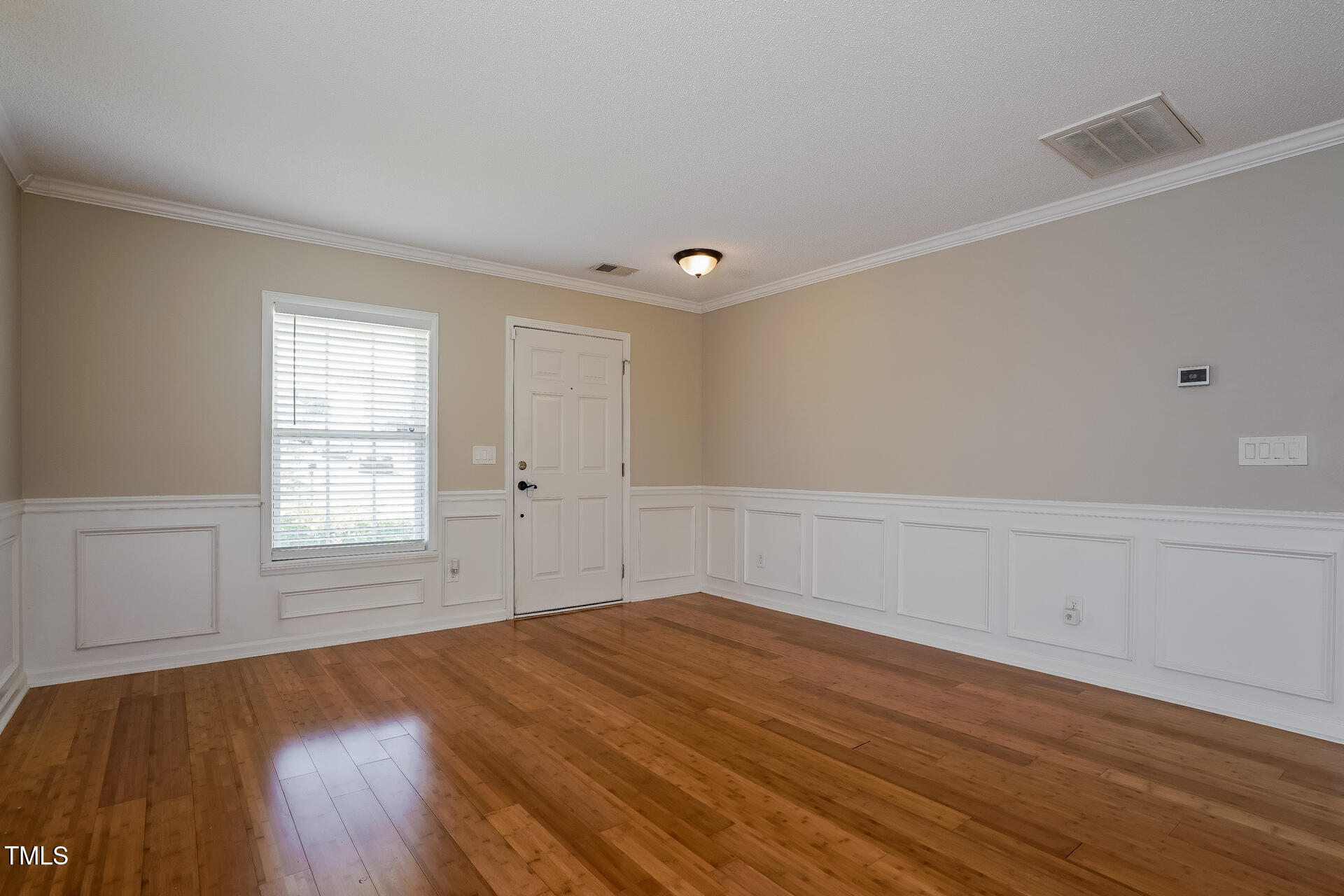 6101 Ricker Road Raleigh, NC 27610 - Photo 8 of 24 a view of empty room with wooden floor and fan