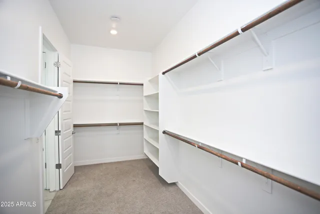 a kitchen with granite countertop a sink a counter top space cabinets stainless steel appliances and a window