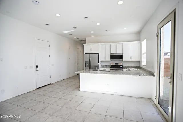 a kitchen with a sink window and cabinets