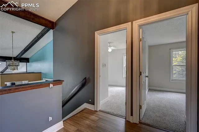 a view of hallway with wooden floor