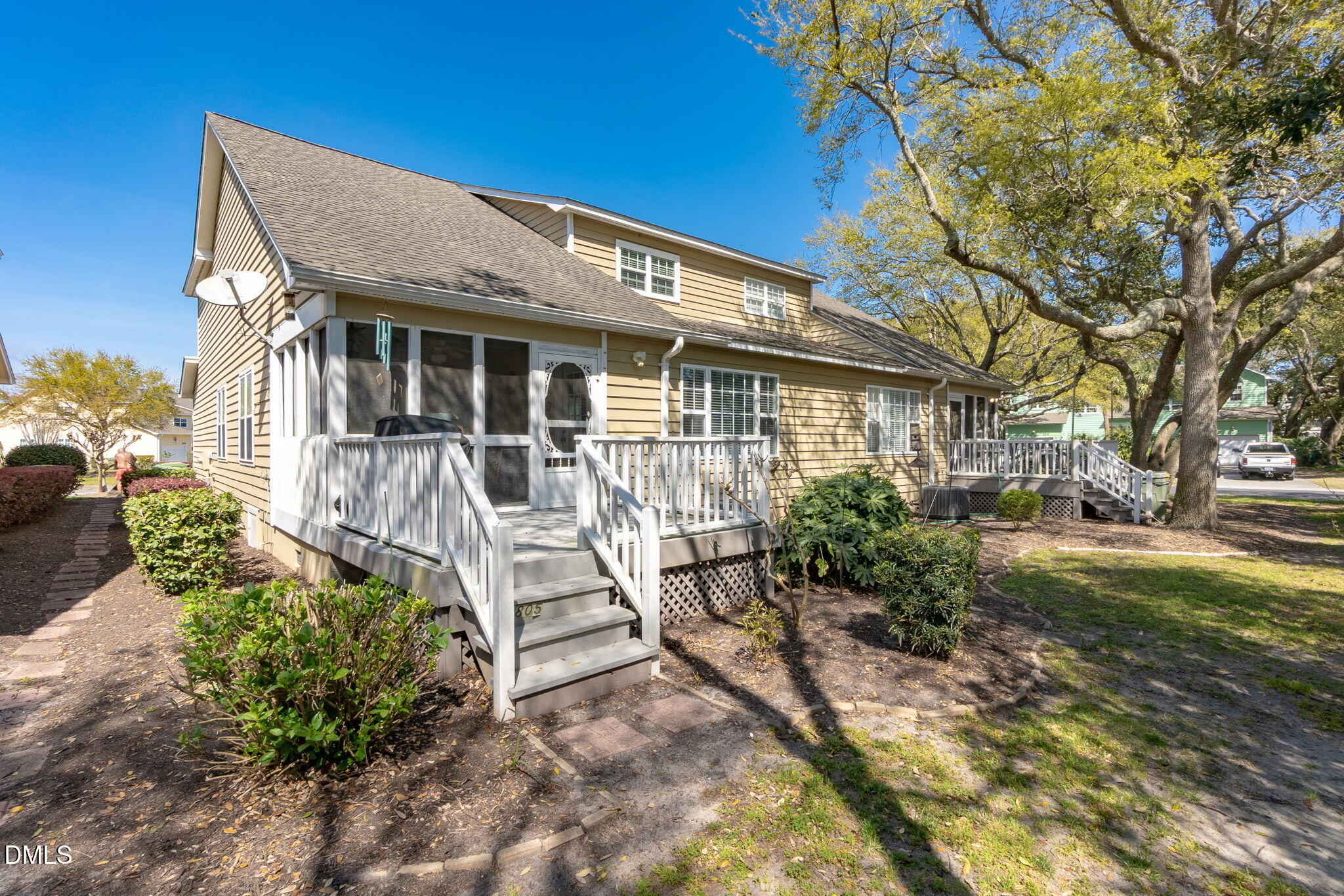805 Sloop Pointe Lane Kure Beach, NC 28449 - Photo 16 of 20 a front view of a house with garden