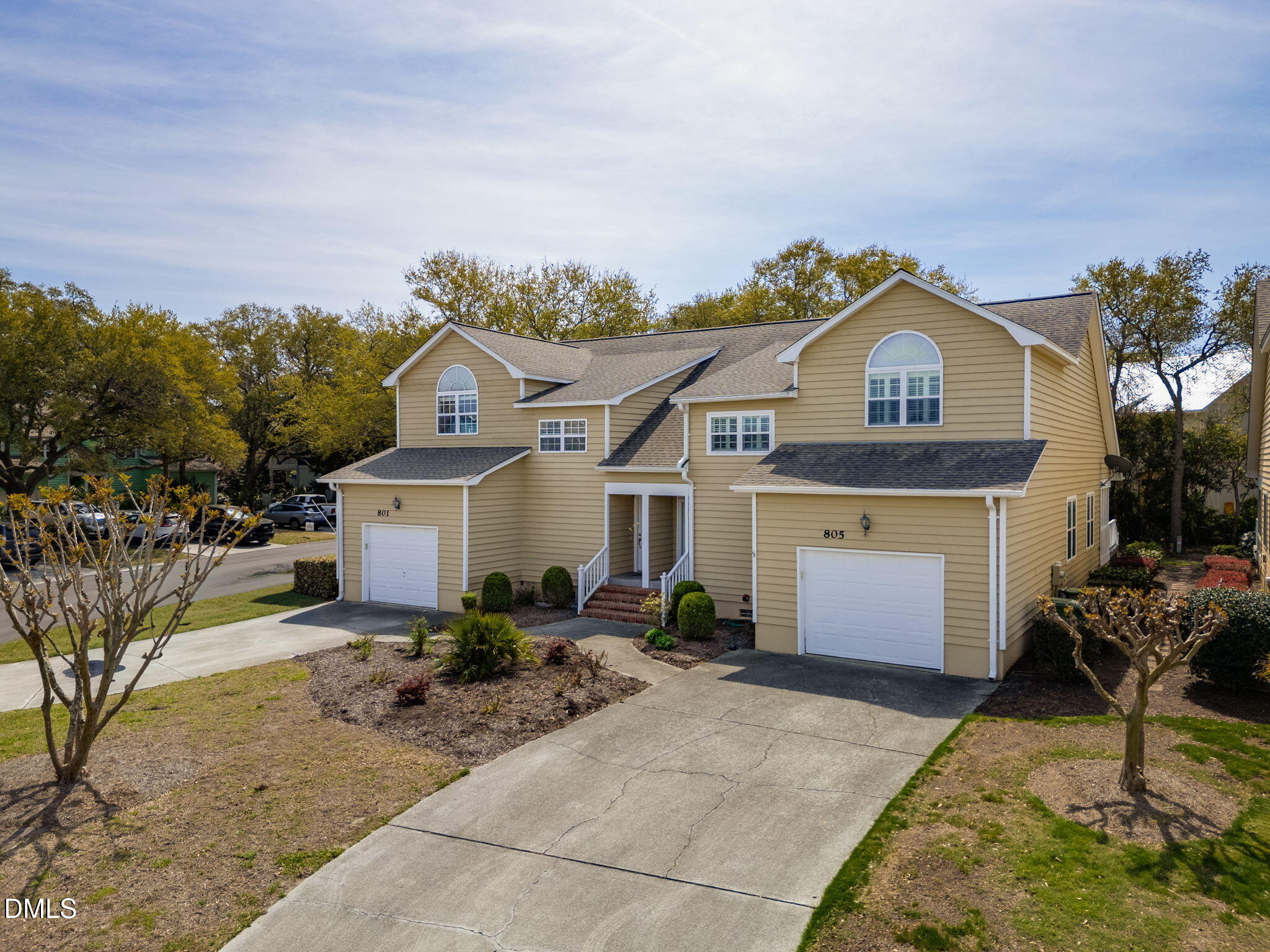 805 Sloop Pointe Lane Kure Beach, NC 28449 - Photo 18 of 20 a front view of a house with a yard and garage