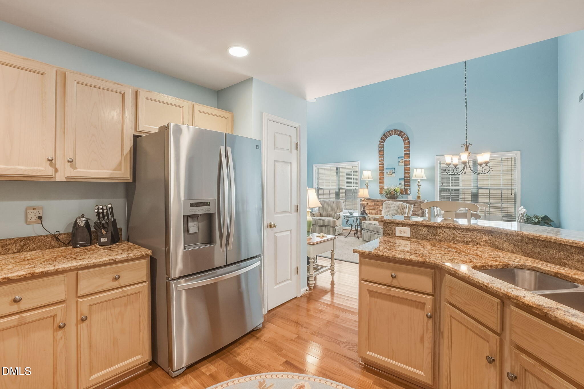 805 Sloop Pointe Lane Kure Beach, NC 28449 - Photo 5 of 20 a kitchen with stainless steel appliances a refrigerator sink and cabinets