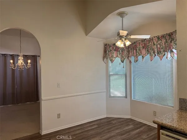 an empty room with windows and cabinet