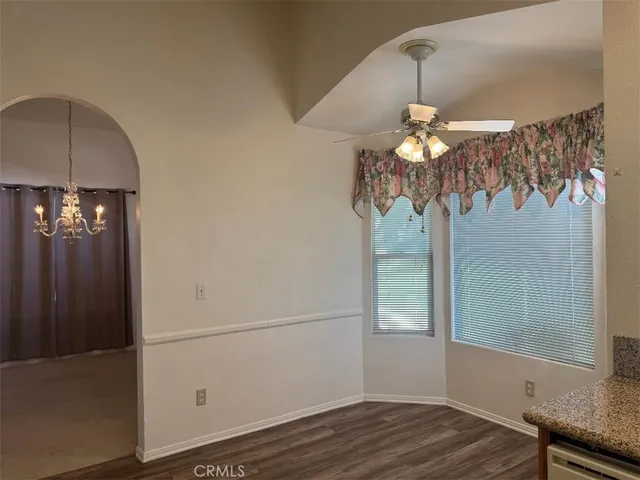 an empty room with windows and cabinet