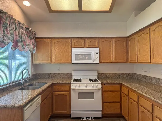a kitchen with a white cabinets and white appliances
