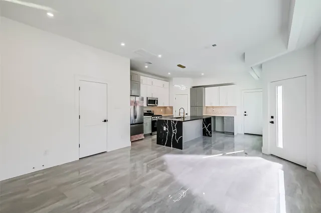 a kitchen with stainless steel appliances a refrigerator and a stove top oven