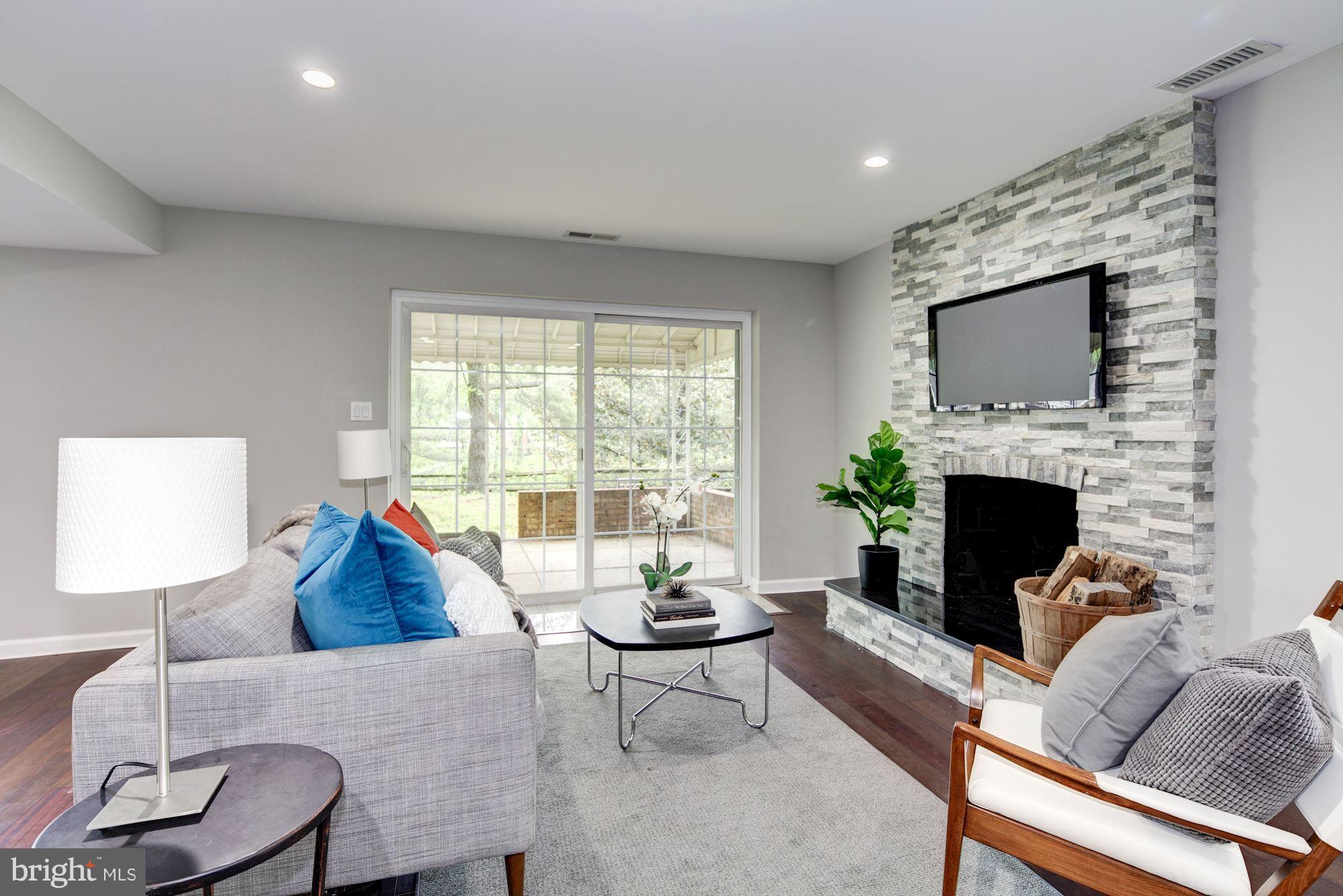 1301 Midmeadow Road Towson, MD 21286 - Photo 11 of 30 a living room with furniture a fireplace and a flat screen tv