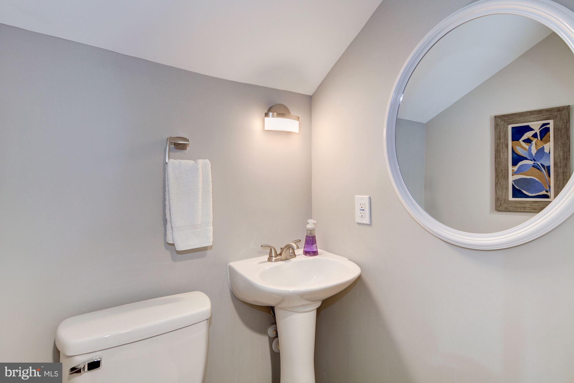 1301 Midmeadow Road Towson, MD 21286 - Photo 14 of 30 a bathroom with a toilet sink and mirror