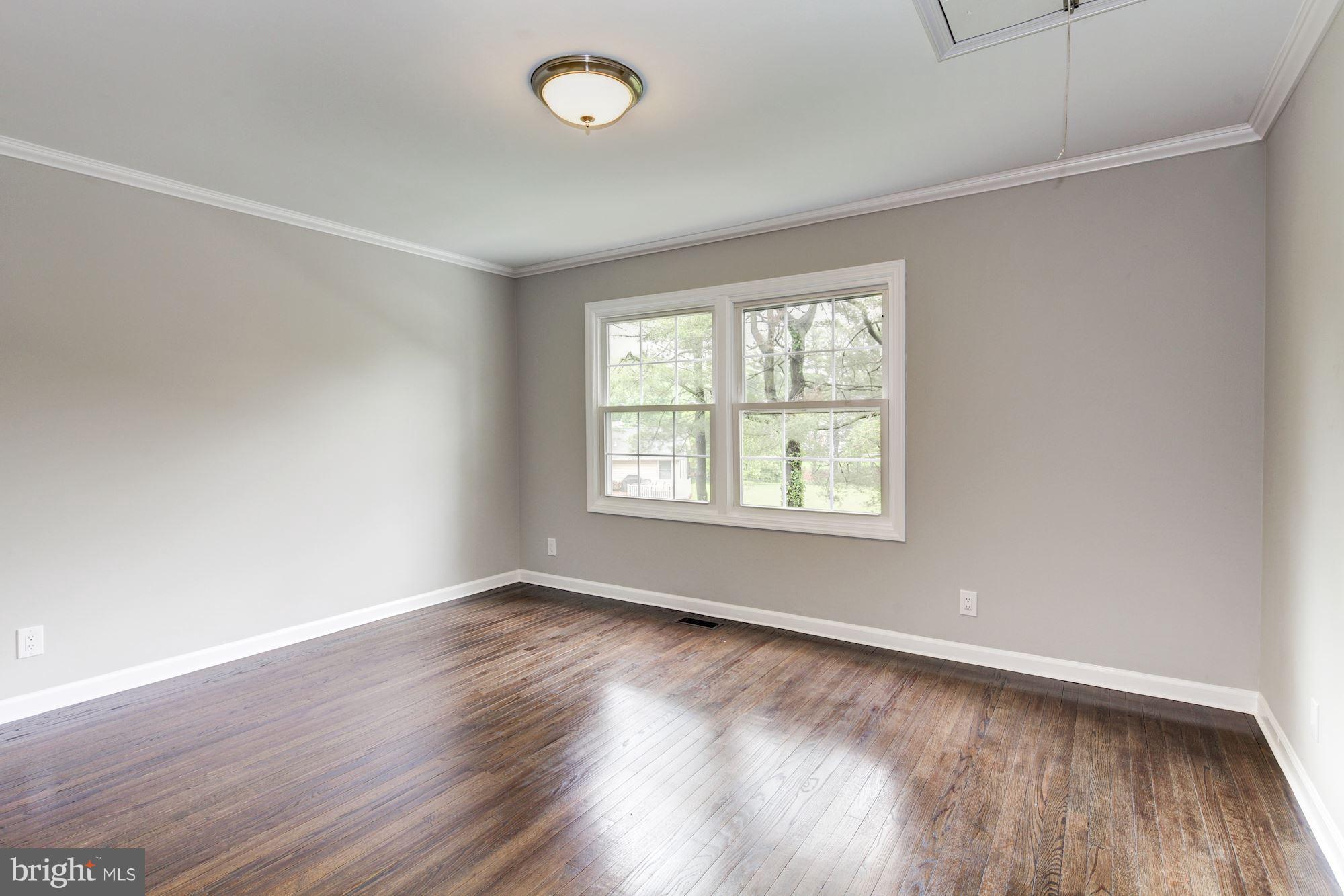 1301 Midmeadow Road Towson, MD 21286 - Photo 24 of 30 an empty room with wooden floor and windows