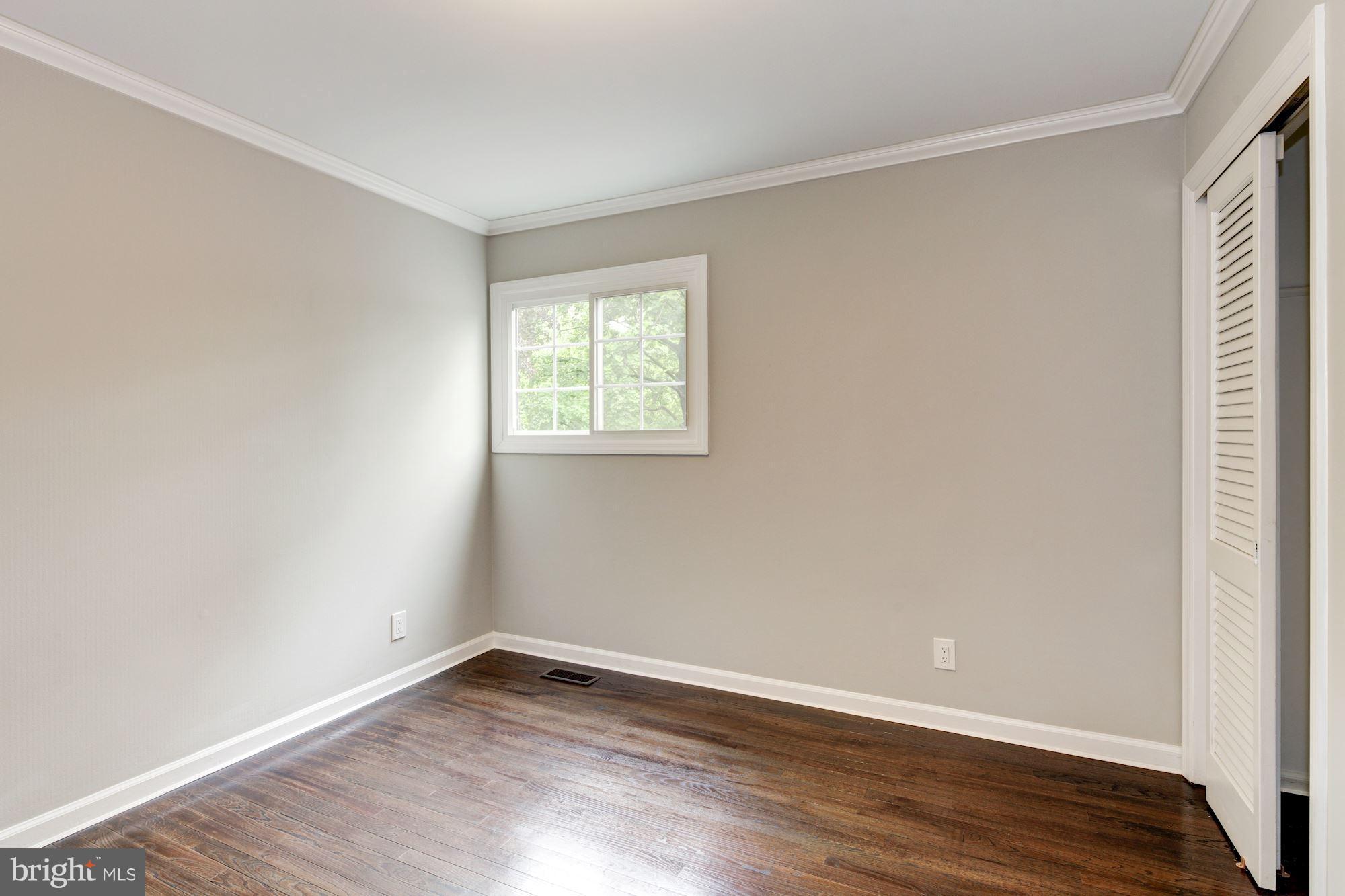 1301 Midmeadow Road Towson, MD 21286 - Photo 25 of 30 an empty room with wooden floor and windows