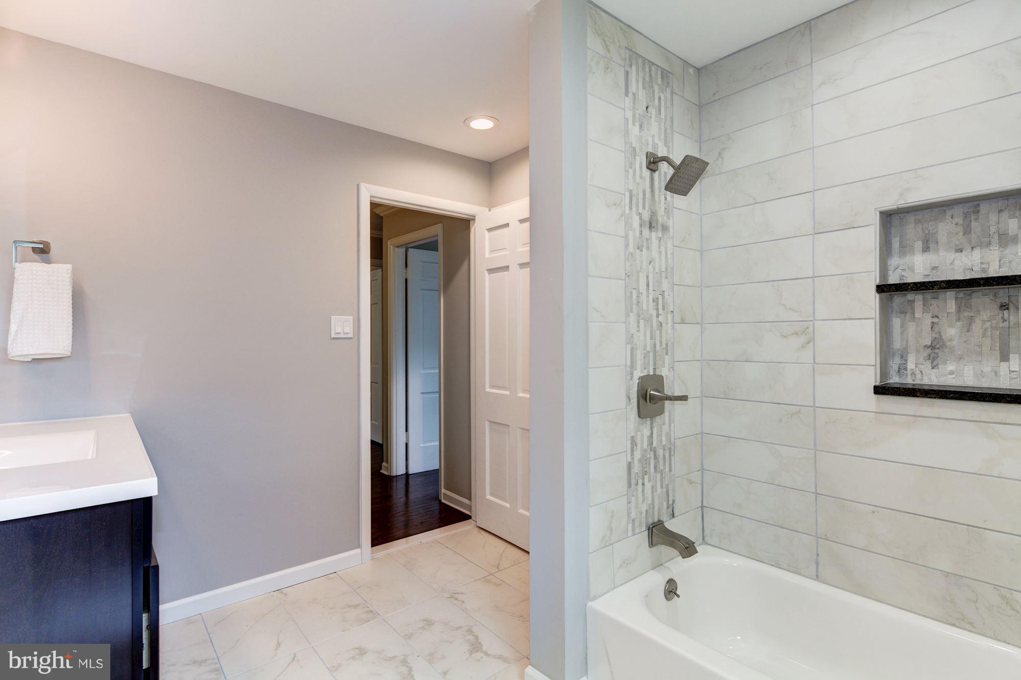 1301 Midmeadow Road Towson, MD 21286 - Photo 27 of 30 a bathroom with a bathtub and a shower