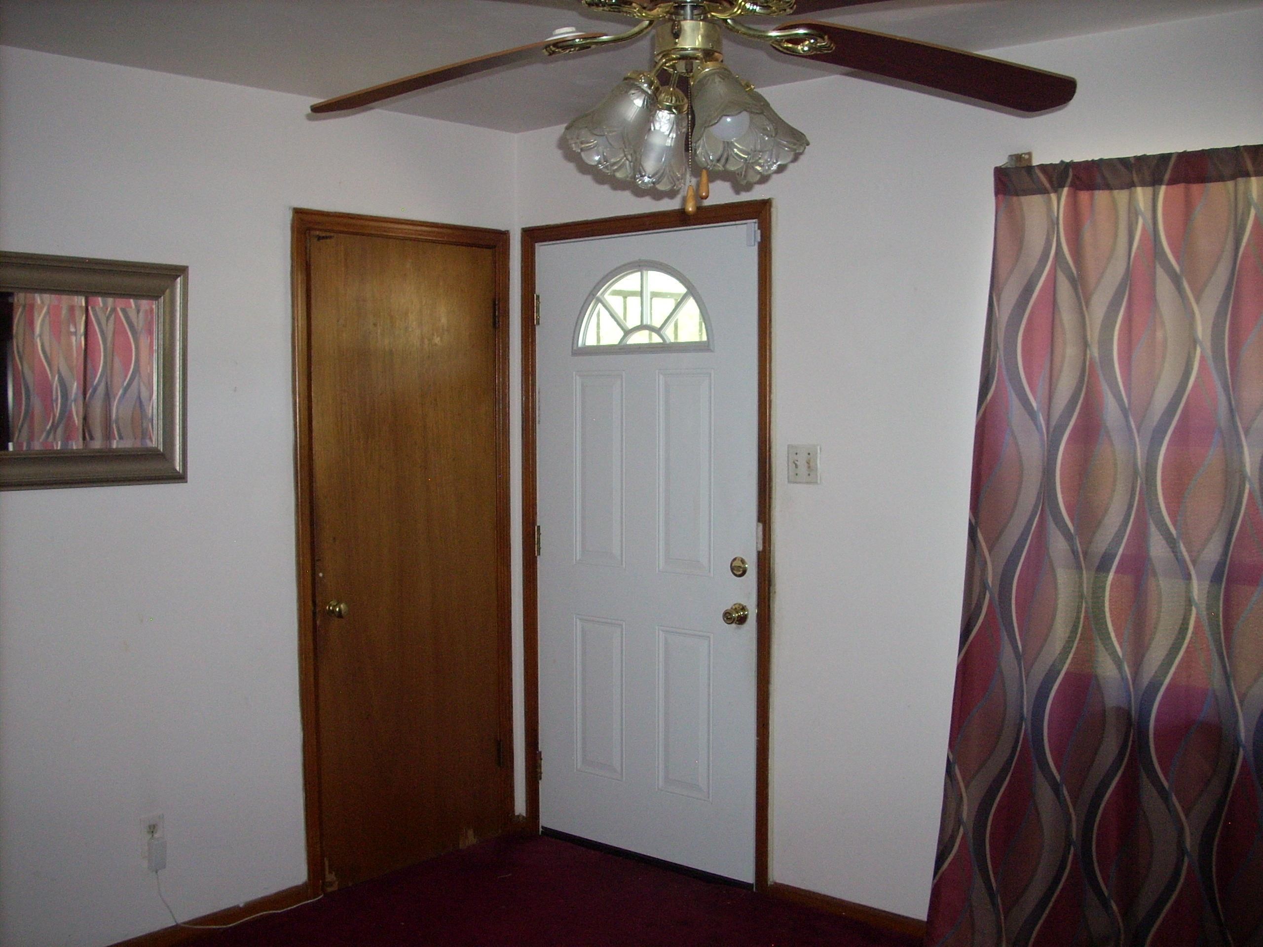 4282 Westmont Road Memphis, TN 38109 - Photo 12 of 15 White paneled entry door with an arched decorative window