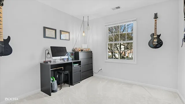 a view of a workspace with furniture and a window