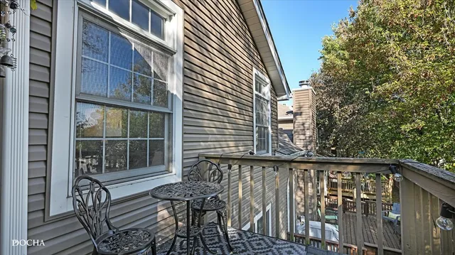 a view of a chair and table in the balcony