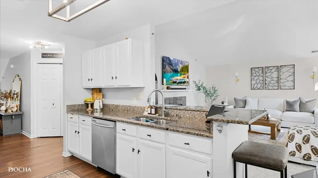 a kitchen with granite countertop white cabinets and white appliances