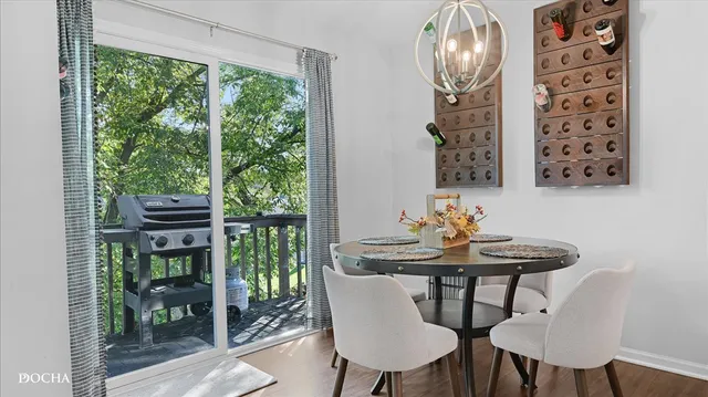 a view of a dining room with furniture wooden floor and a potted plant