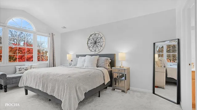 a bedroom with a bed and a table