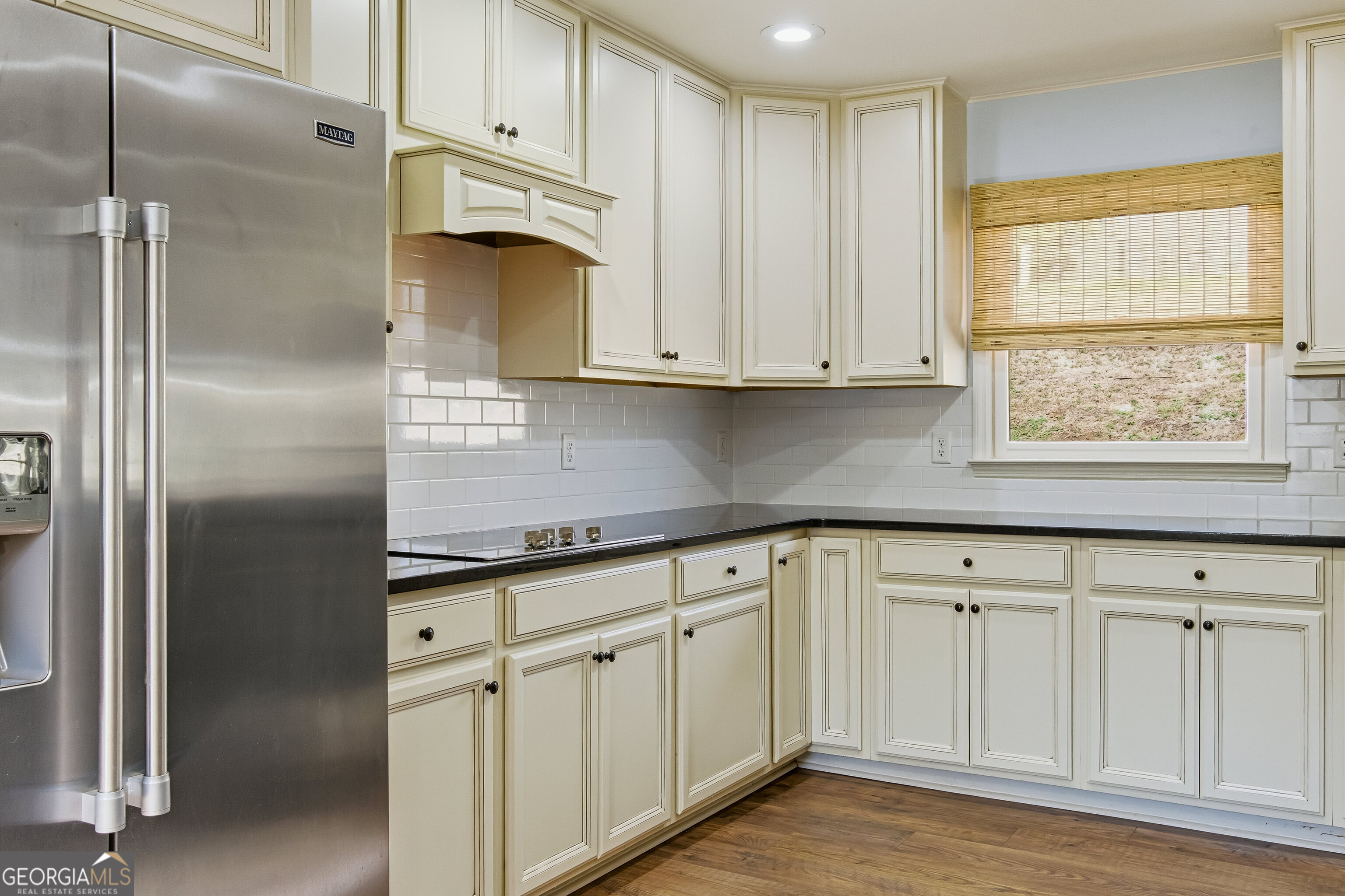 3302 Hickory Point Gainesville, GA 30506 - Photo 15 of 73 a kitchen with white cabinets and a refrigerator