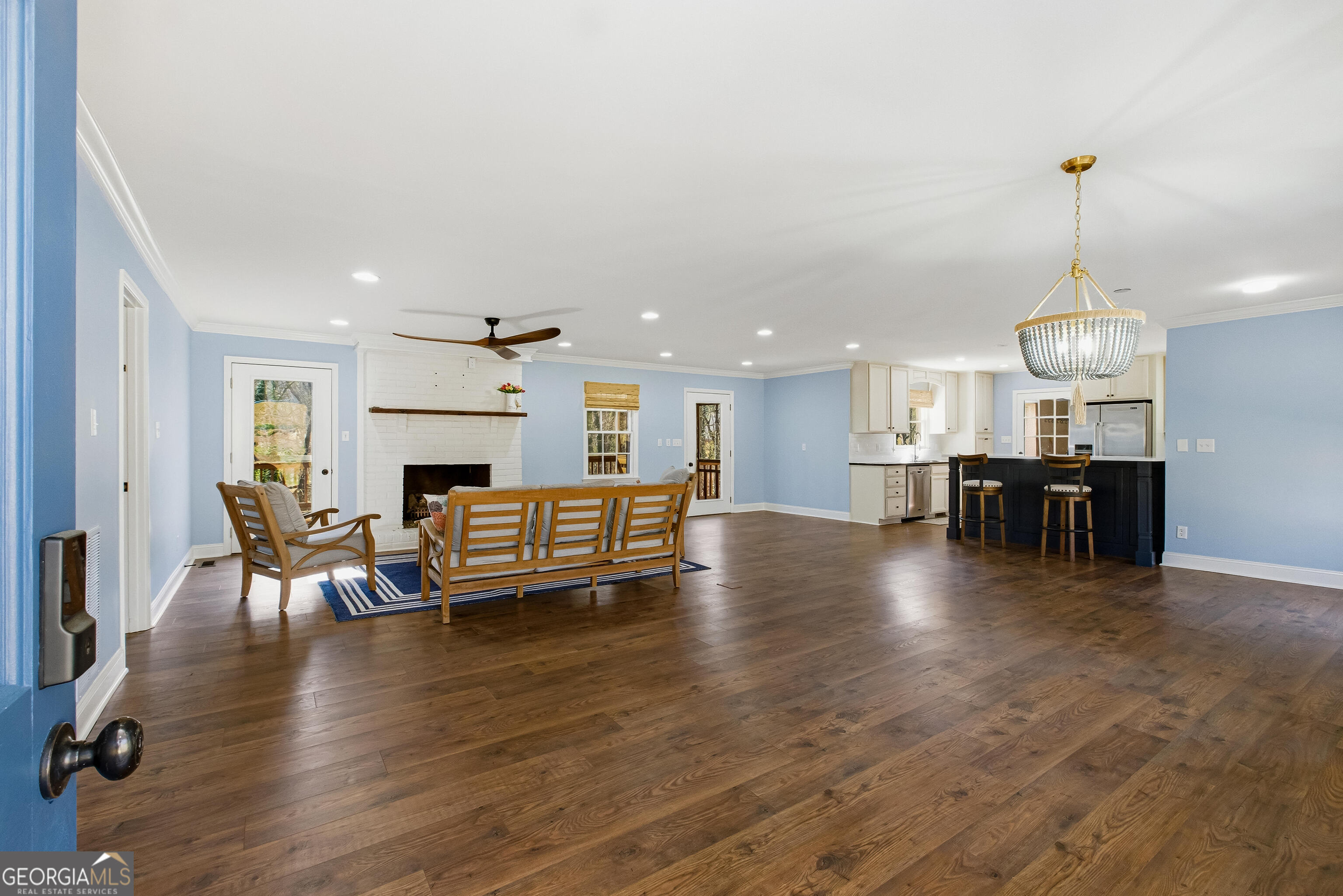 3302 Hickory Point Gainesville, GA 30506 - Photo 8 of 73 a view of a dining room with furniture chandelier fireplace and wooden floor