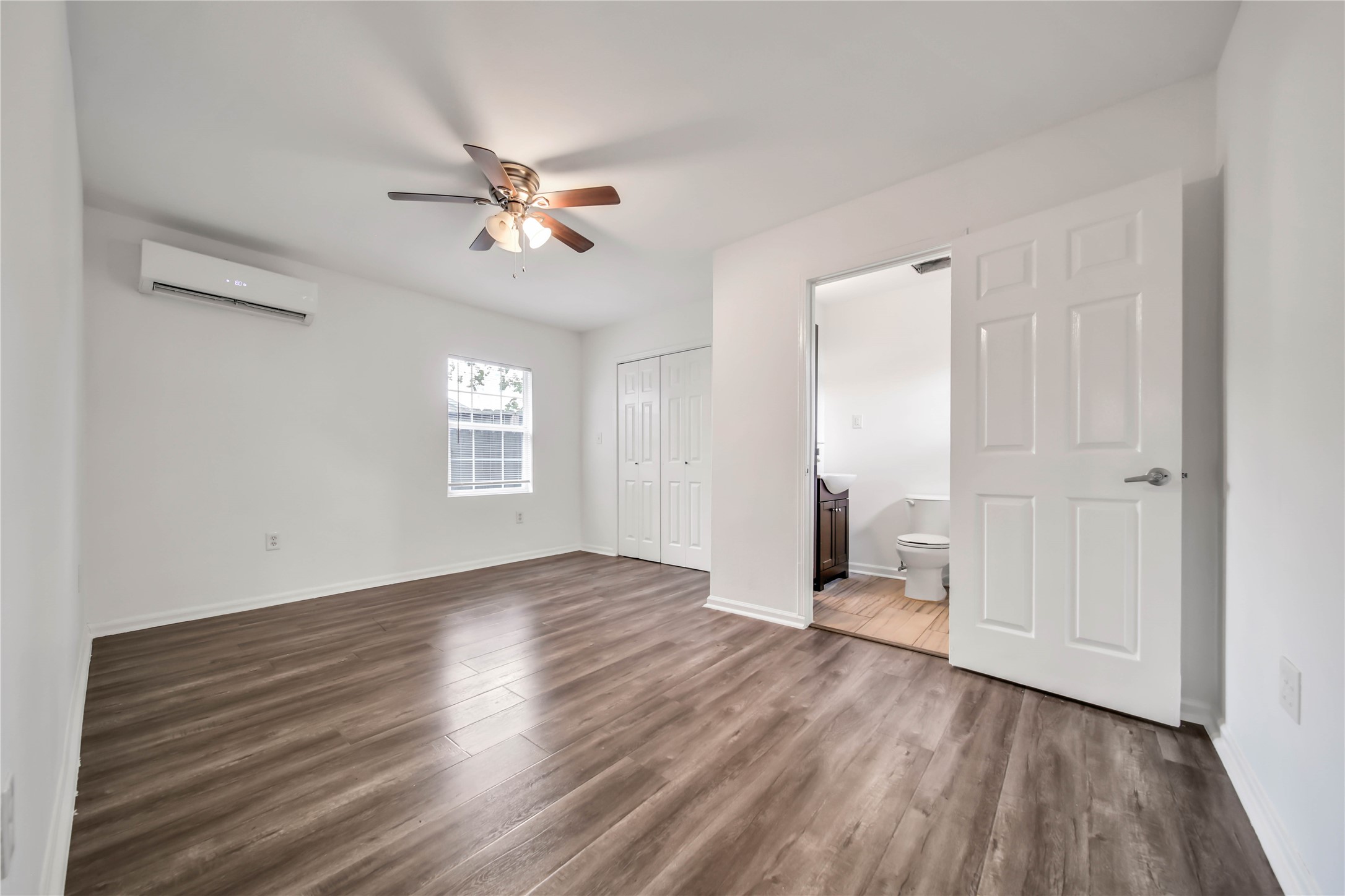 1710 Shelby Street, Unit A Houston, TX 77009 - Photo 14 of 20 wooden floor in an empty room with a window