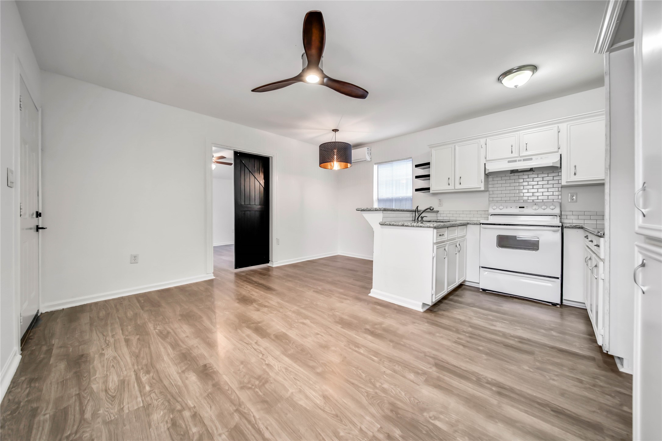 1710 Shelby Street, Unit A Houston, TX 77009 - Photo 2 of 20 a kitchen with a stove a sink and a refrigerator