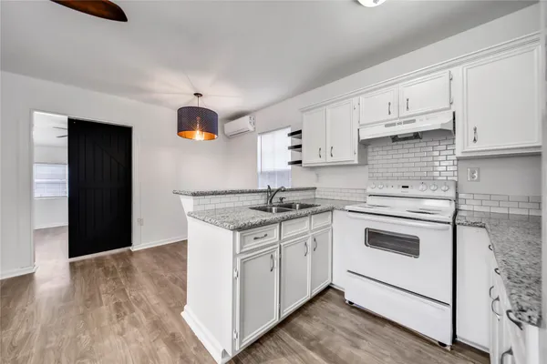 a kitchen with stainless steel appliances granite countertop a sink and cabinets
