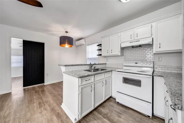 a kitchen with stainless steel appliances granite countertop a sink and cabinets