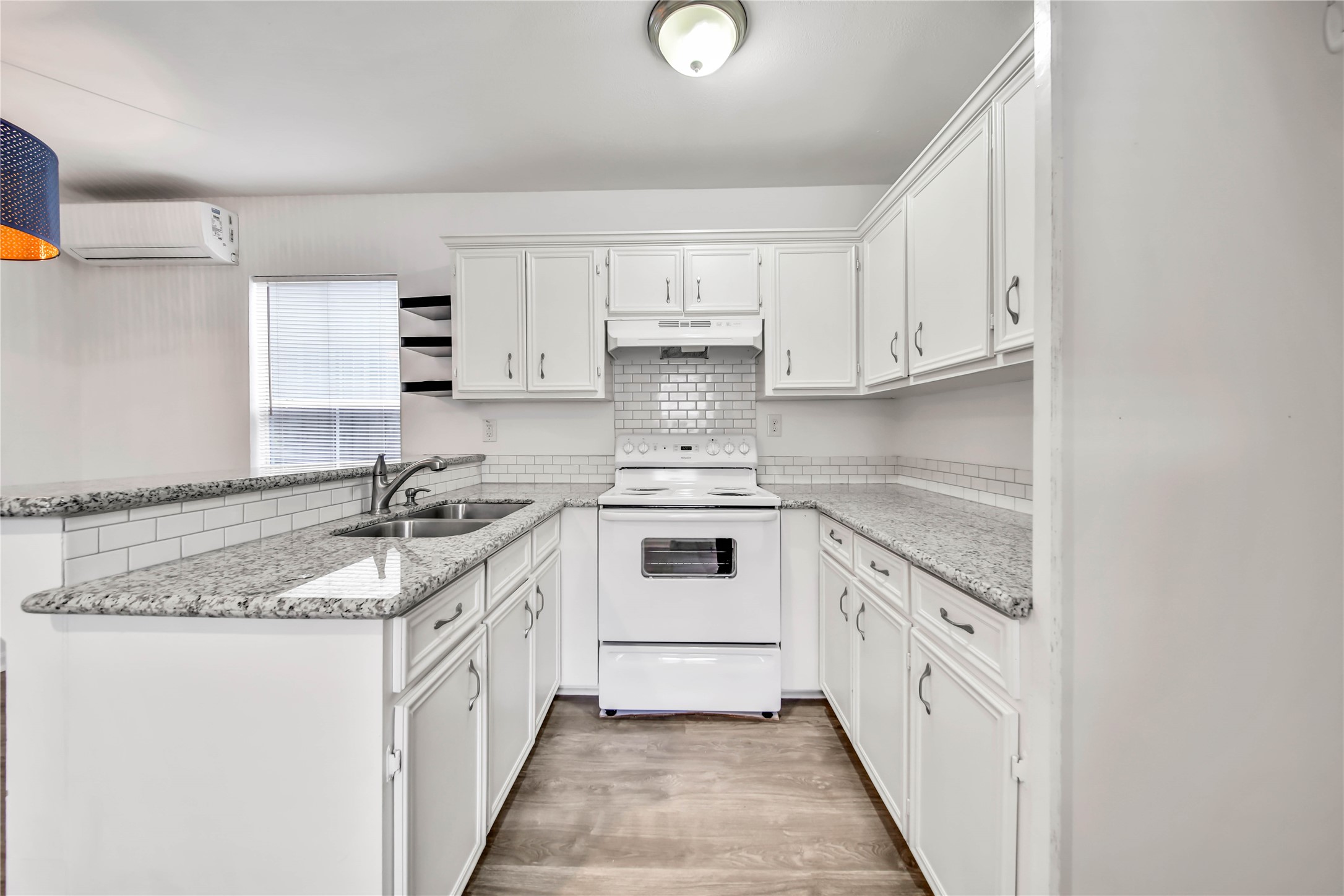 1710 Shelby Street, Unit A Houston, TX 77009 - Photo 5 of 20 a kitchen with granite countertop a sink stove and cabinets