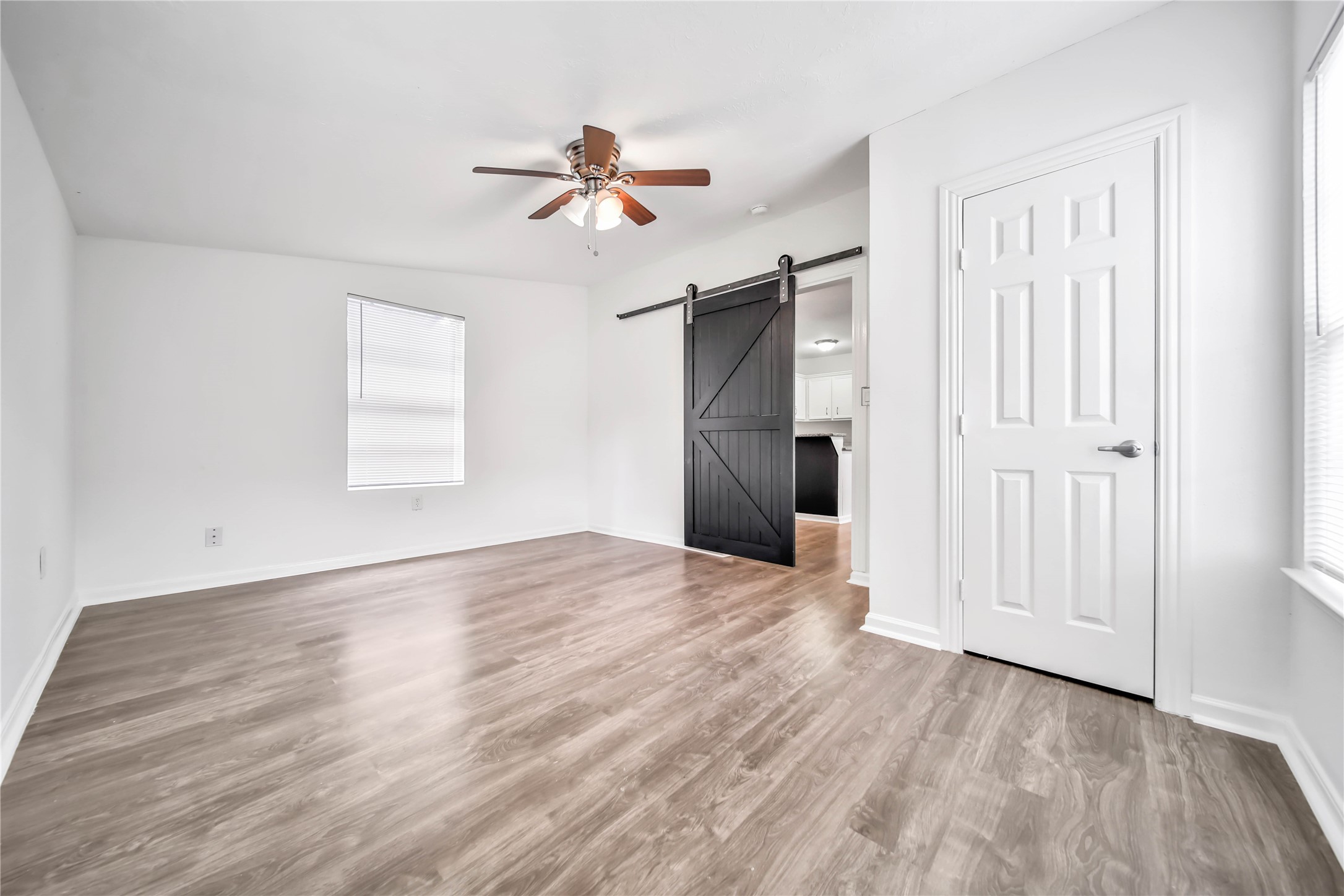 1710 Shelby Street, Unit A Houston, TX 77009 - Photo 8 of 20 an empty room with wooden floor closet and windows