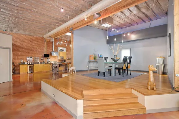 a bedroom with a bed and a table chair