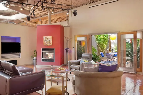 a view of a dining room with furniture and a potted plant