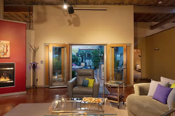 a view of a chairs and table in backyard with plants