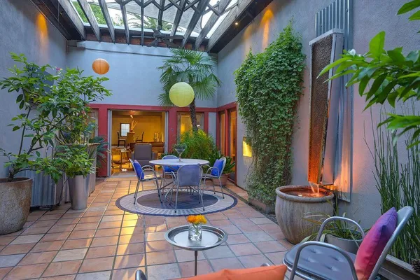 a backyard of a house with outdoor seating