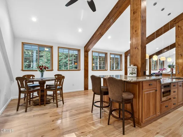 a dining room with furniture a window and wooden floor