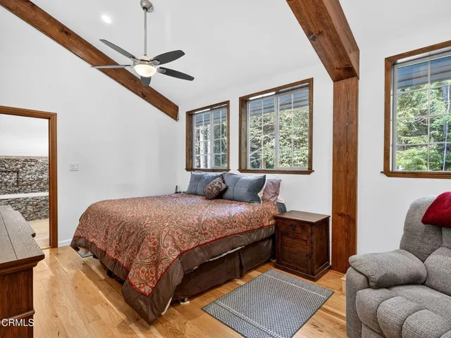 a bedroom with a bed couch and window