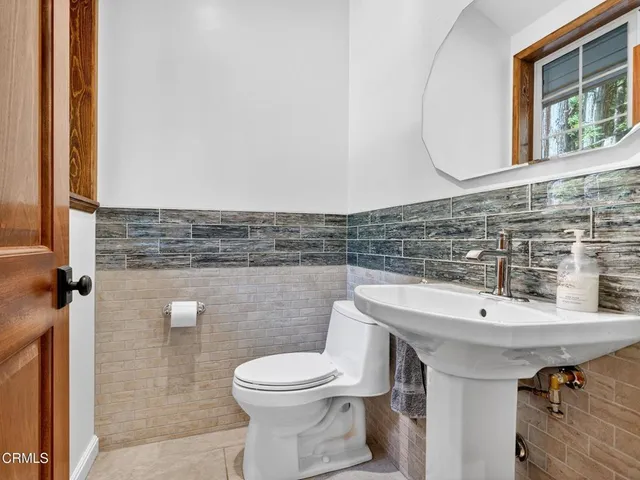 a view of a deck with two chair and wooden floor