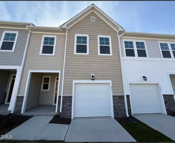 a front view of a house with a garage