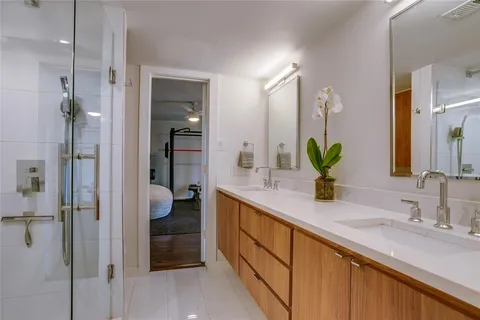 a bathroom with a double vanity sink and a mirror