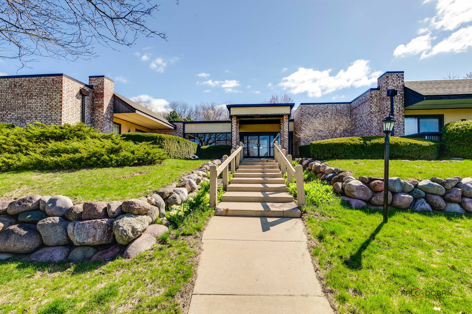 a view of a house with backyard and patio