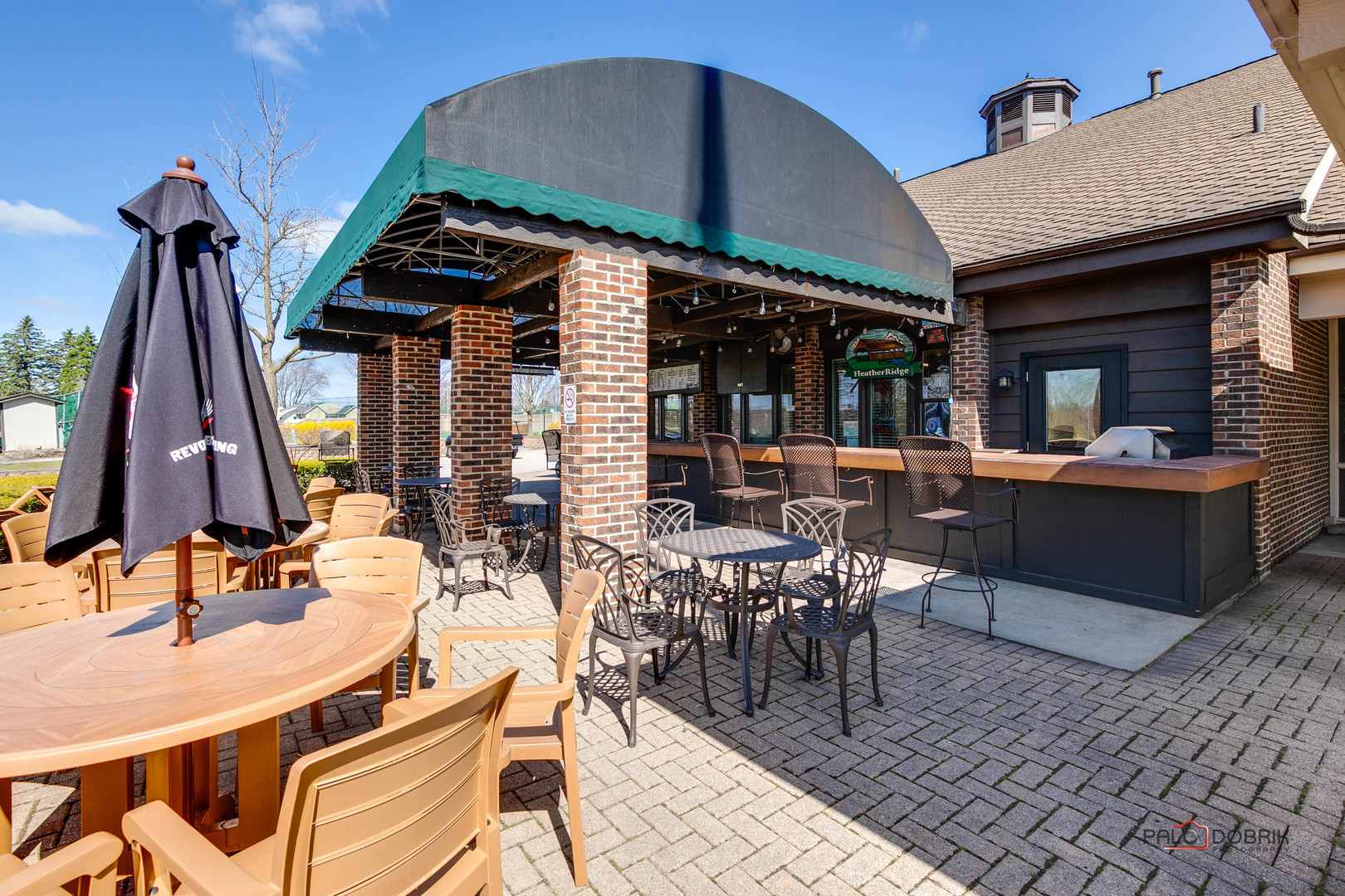 5844 Heather Ridge Drive, Unit 105 Gurnee, IL 60031 - Photo 21 of 25 a view of a dining table and chairs in the patio