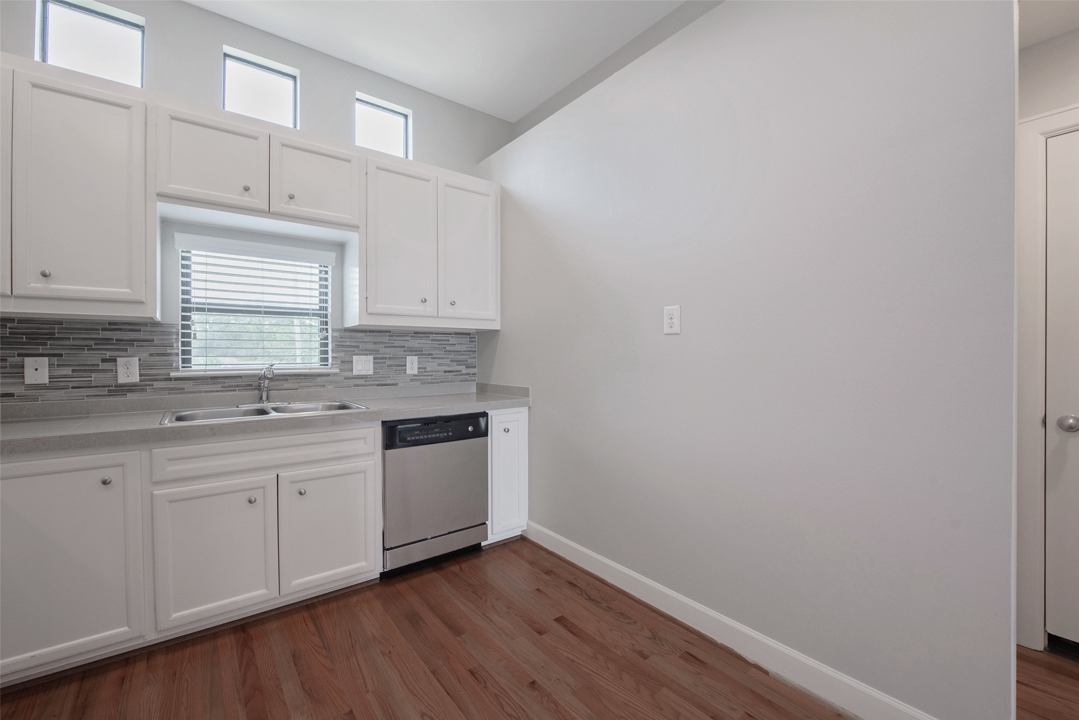 7650 Springhill Street, Unit 603 Houston, TX 77021 - Photo 11 of 26 a kitchen with sink cabinets and wooden floor