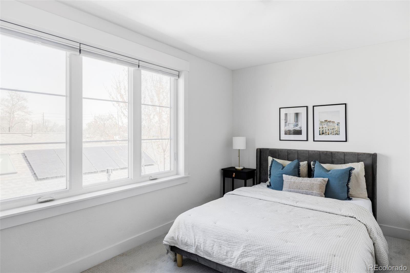 3927 Cook Street Denver, CO 80205 - Photo 22 of 35 a bedroom with a bed and a window